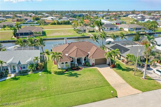 drone / aerial view featuring a water view and a residential view