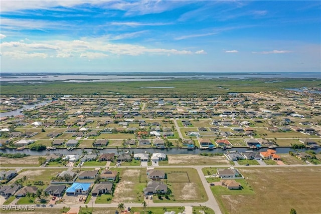 drone / aerial view with a residential view and a water view