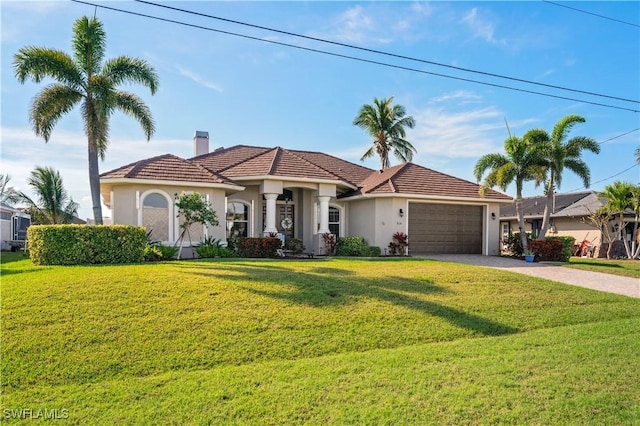 mediterranean / spanish-style home with driveway, a garage, a chimney, a front lawn, and stucco siding