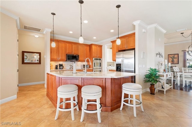 kitchen with stainless steel appliances, a large island, a kitchen bar, and visible vents