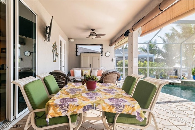 sunroom featuring a ceiling fan