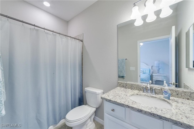 ensuite bathroom with vanity, toilet, and ensuite bathroom