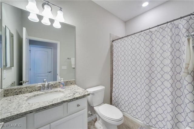 bathroom featuring curtained shower, vanity, and toilet