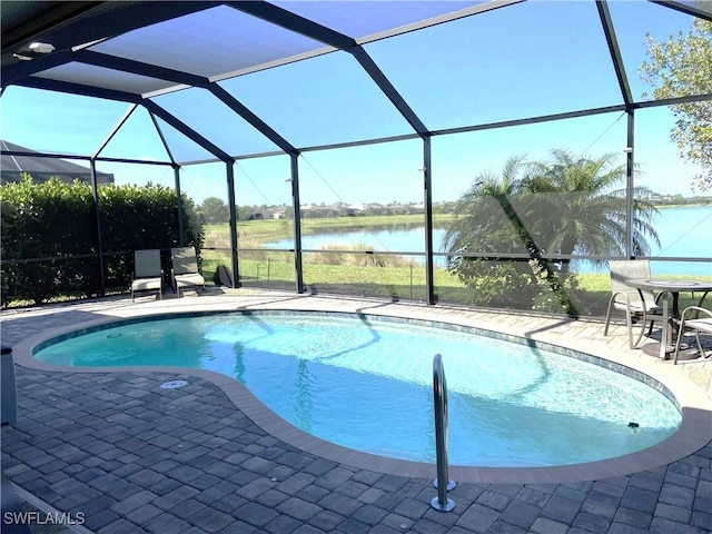 pool featuring a patio, a water view, and a lanai