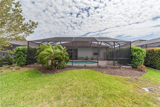 back of house with glass enclosure, an outdoor pool, and a yard