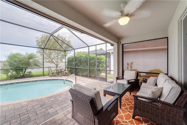 outdoor pool featuring a patio area, a lanai, an outdoor living space, and a ceiling fan