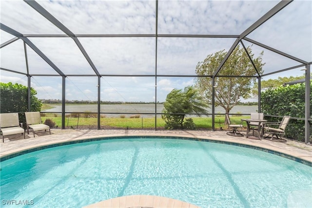 pool with glass enclosure and a patio area