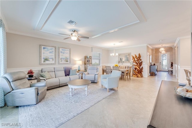 living room with ornamental molding, a healthy amount of sunlight, visible vents, and ceiling fan with notable chandelier