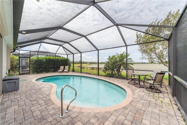 outdoor pool featuring glass enclosure and a patio area