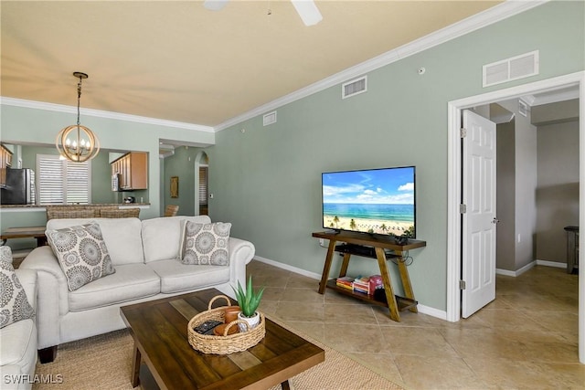 living room with arched walkways, visible vents, and crown molding