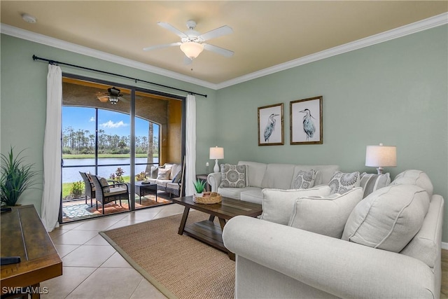 living area with a water view, crown molding, a ceiling fan, and light tile patterned flooring