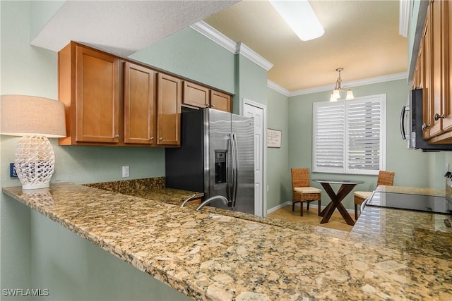 kitchen with hanging light fixtures, brown cabinetry, ornamental molding, and stainless steel appliances