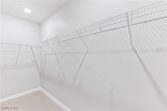 spacious closet with light tile patterned floors