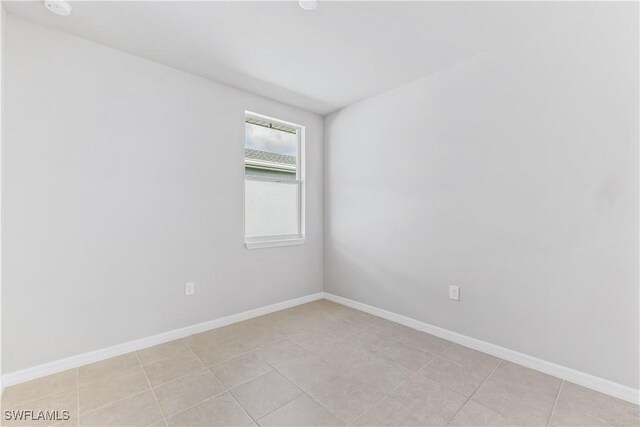 spare room featuring baseboards