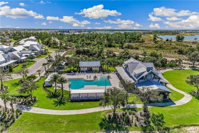 bird's eye view of a pool area and a large body of water