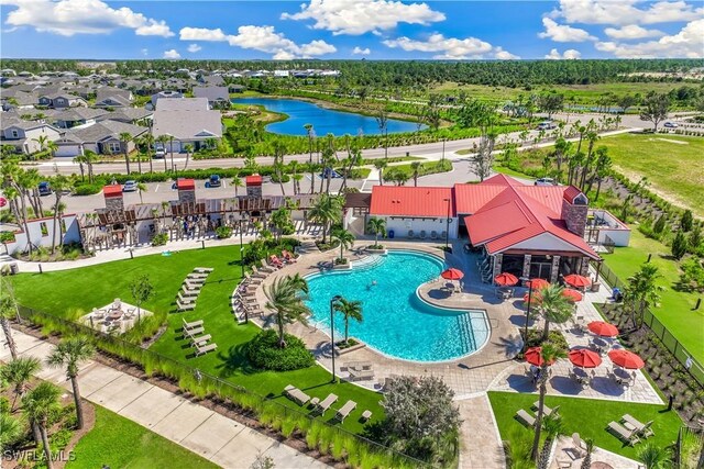 drone / aerial view of a large body of water and a pool area
