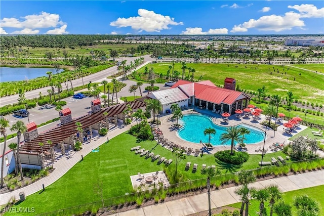 bird's eye view of a pool area and a nearby body of water