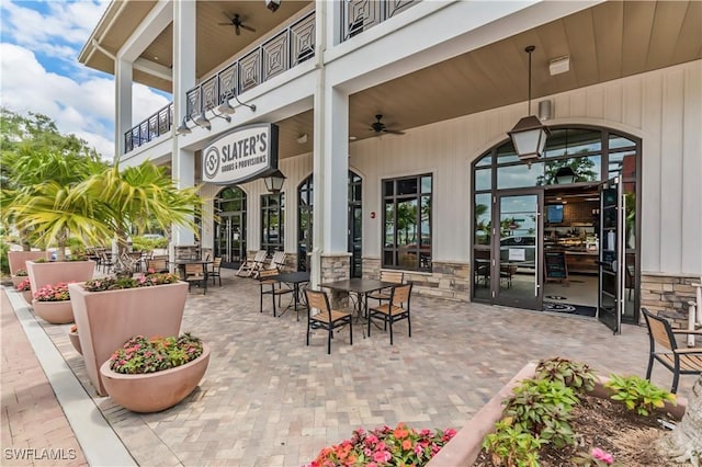 view of patio / terrace with a ceiling fan and a balcony