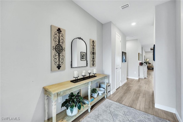 corridor with recessed lighting, wood finished floors, visible vents, and baseboards