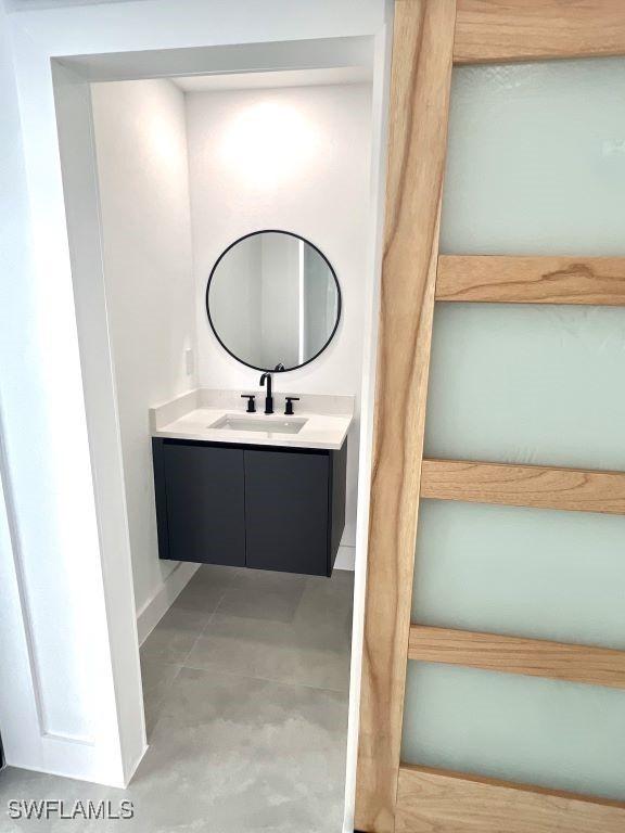 bathroom with vanity and baseboards