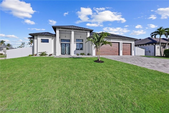 view of front of property featuring metal roof, a front lawn, a standing seam roof, and fence