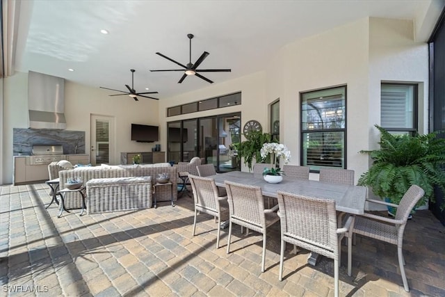 view of patio / terrace with outdoor dining area, a ceiling fan, outdoor lounge area, and exterior kitchen