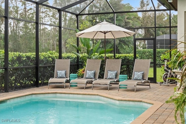 pool featuring a patio area and glass enclosure