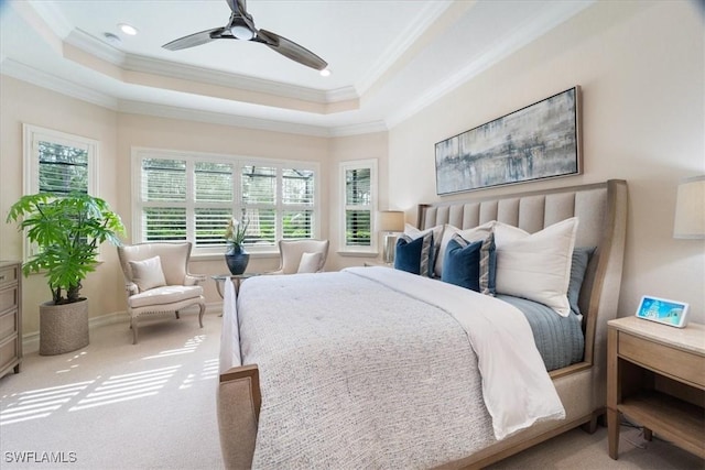 bedroom featuring ornamental molding, a tray ceiling, and carpet floors