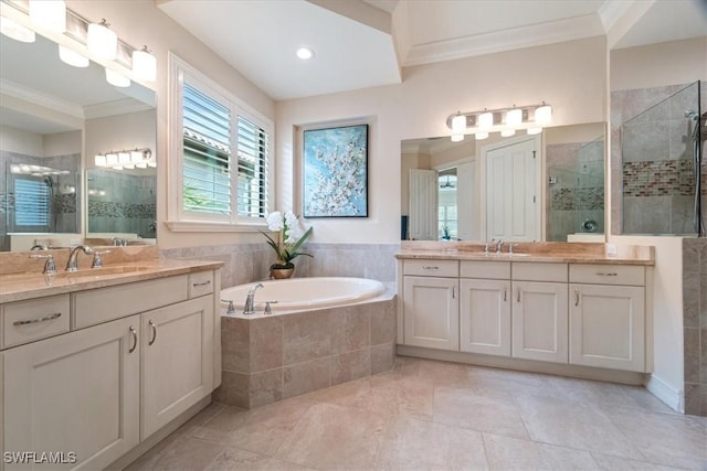 bathroom featuring a garden tub, crown molding, a sink, and a shower stall