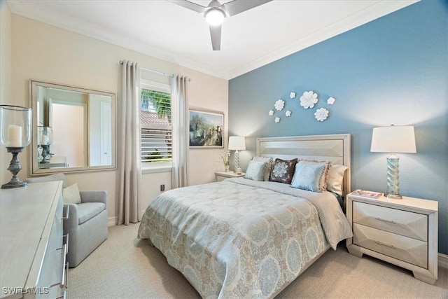 bedroom with carpet, ornamental molding, and a ceiling fan