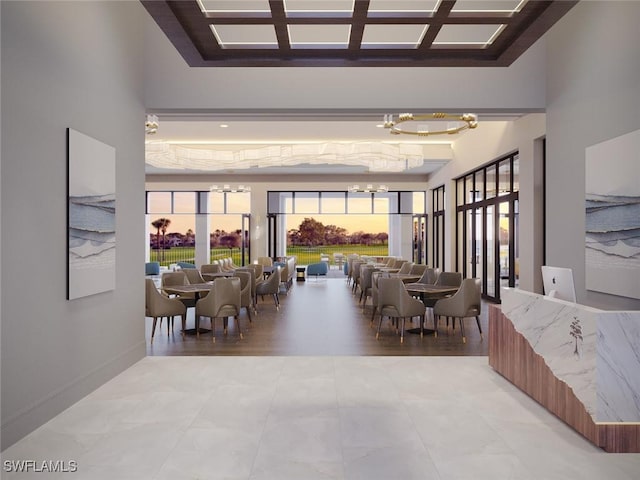 dining room featuring a high ceiling, baseboards, and a notable chandelier