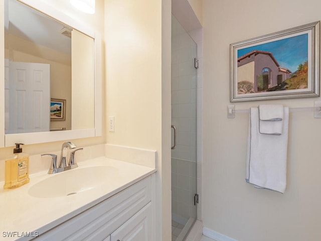 bathroom with a stall shower, visible vents, and vanity