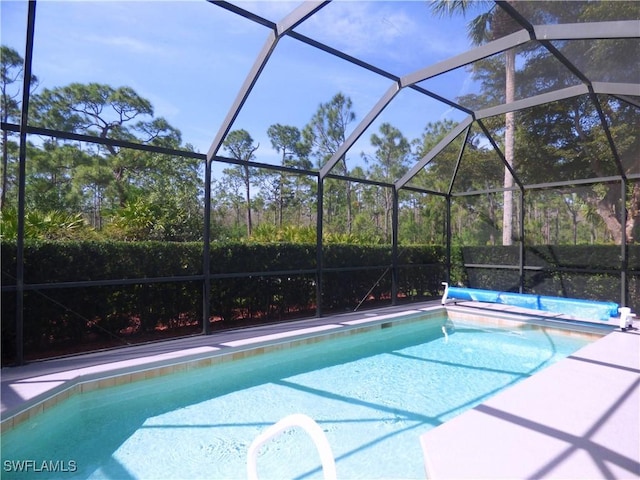 outdoor pool featuring glass enclosure