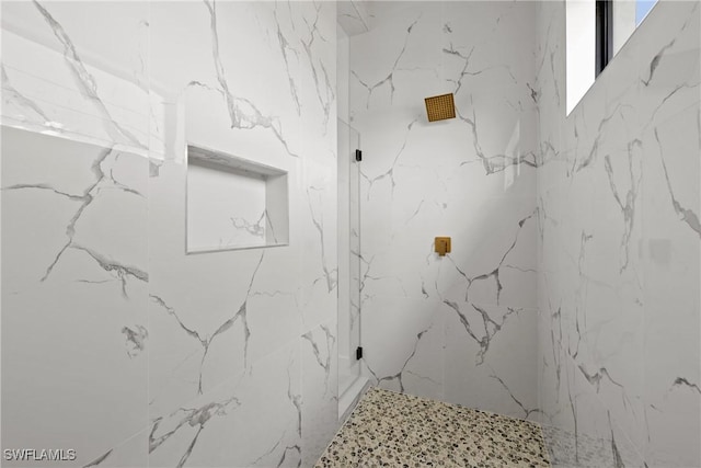 bathroom with a marble finish shower