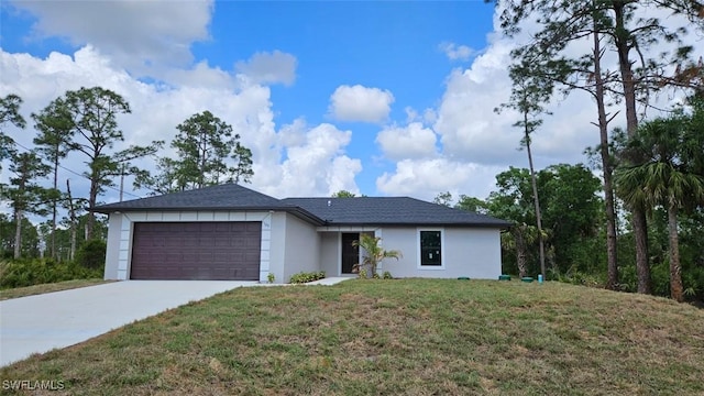 view of front of house featuring a front yard, an attached garage, driveway, and stucco siding