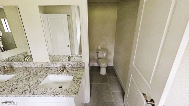 1125 Copley St E, Lehigh Acres, FL 33974 - bathroom with tile patterned flooring, toilet, and double vanity
