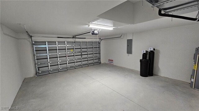 1125 Copley St E, Lehigh Acres, FL 33974 - garage featuring electric panel, electric water heater, and a garage door opener