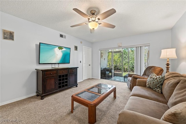 living area featuring visible vents, a ceiling fan, light carpet, a textured ceiling, and baseboards