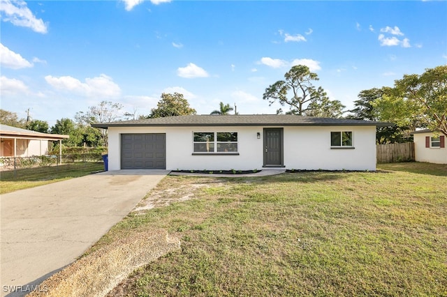 ranch-style home with an attached garage, fence, concrete driveway, stucco siding, and a front yard