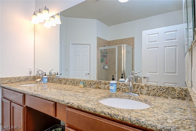 bathroom featuring double vanity, a sink, and a shower stall