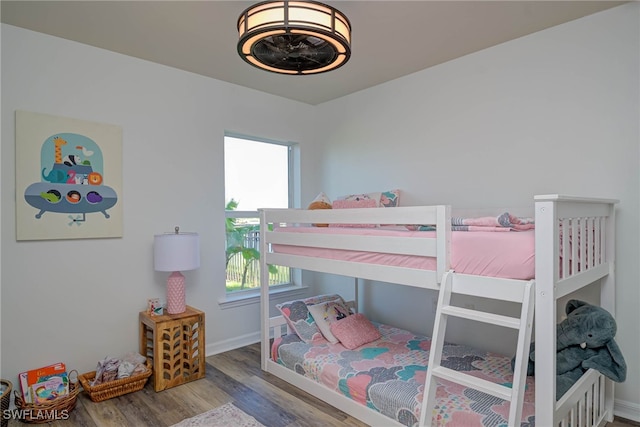 bedroom featuring wood finished floors and baseboards