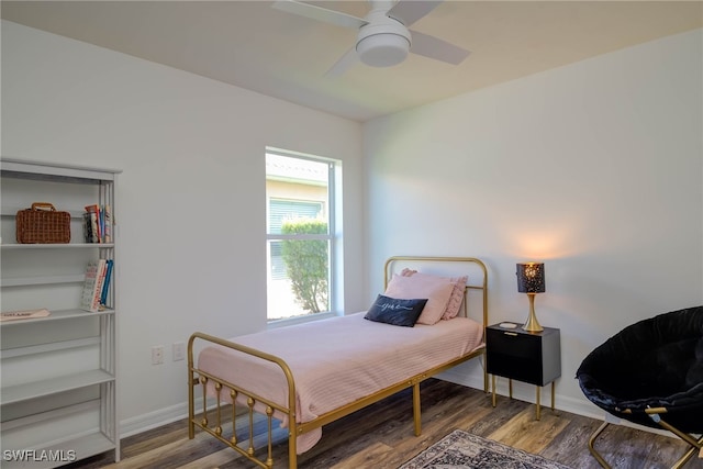 bedroom with wood finished floors, a ceiling fan, and baseboards