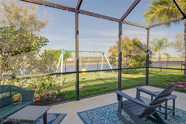 sunroom / solarium featuring a water view