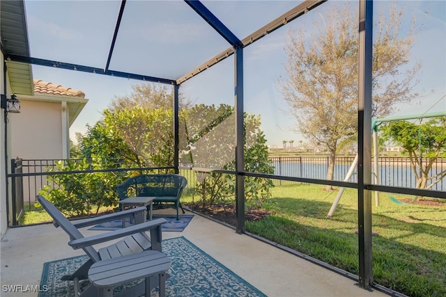 sunroom / solarium featuring a water view