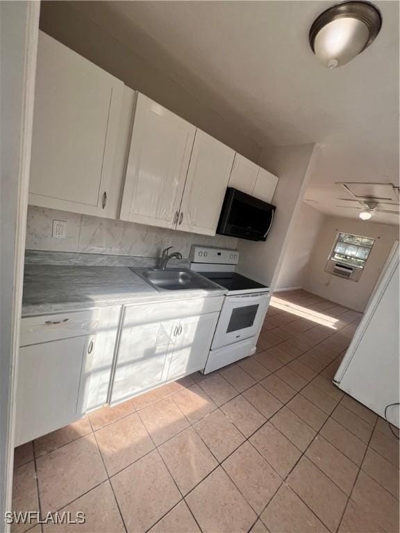 kitchen with light tile patterned floors, light countertops, white electric range, white cabinetry, and a sink