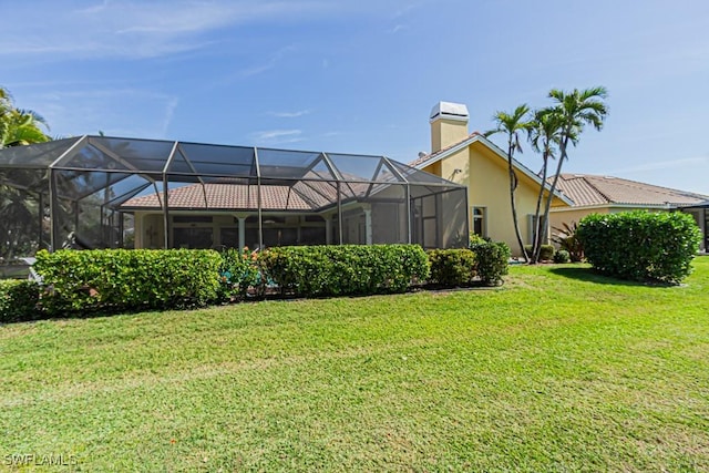 view of yard with glass enclosure