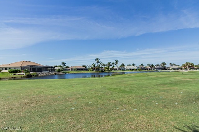 view of community featuring a water view and a yard