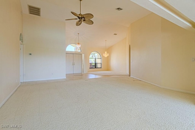 spare room with high vaulted ceiling, ceiling fan with notable chandelier, visible vents, and light colored carpet