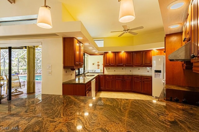 kitchen featuring decorative backsplash, a sink, ceiling fan, white appliances, and under cabinet range hood