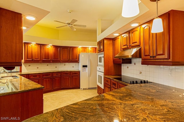 kitchen featuring reddish brown cabinets, hanging light fixtures, a sink, white appliances, and under cabinet range hood